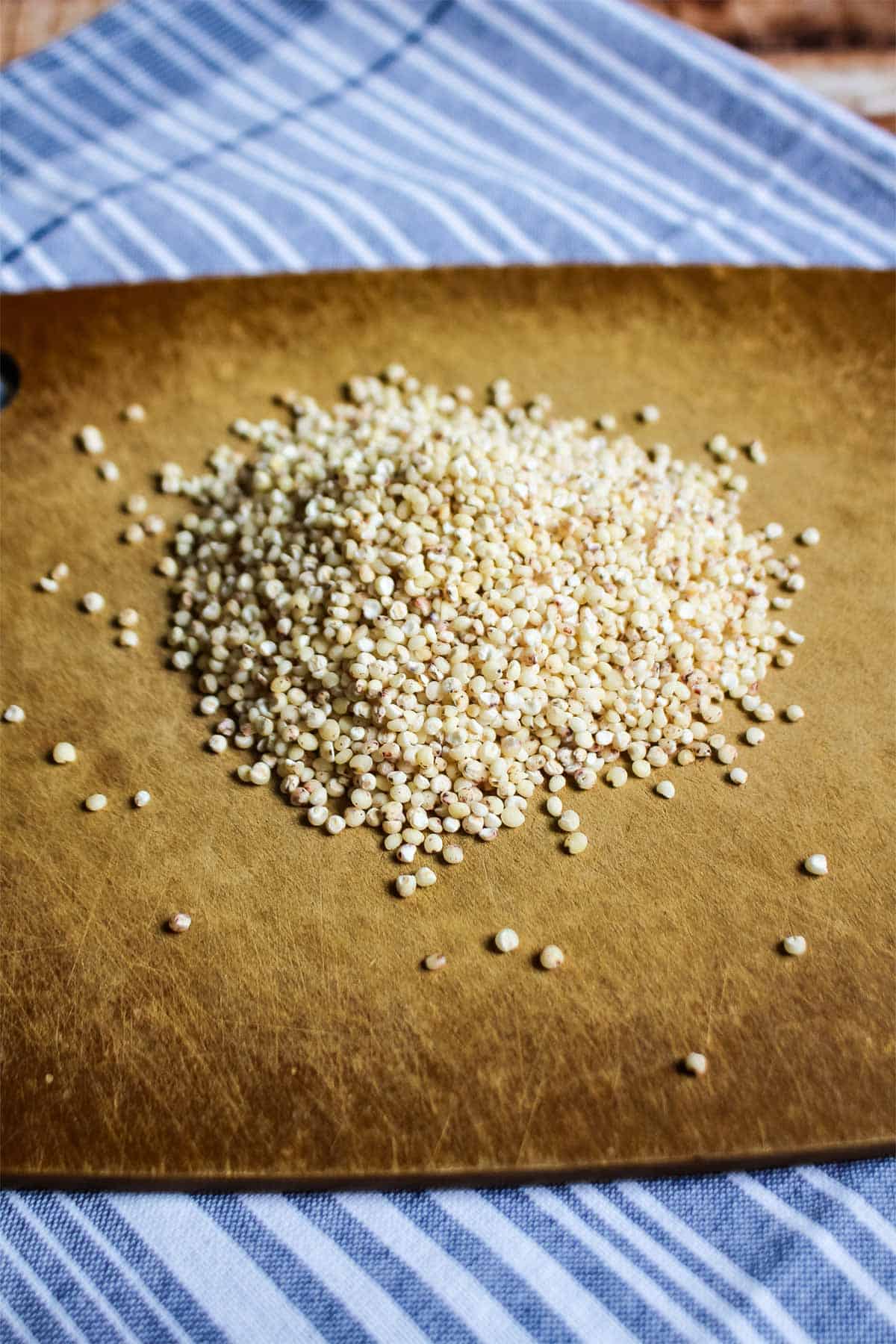 Uncooked sorghum on a cutting board.