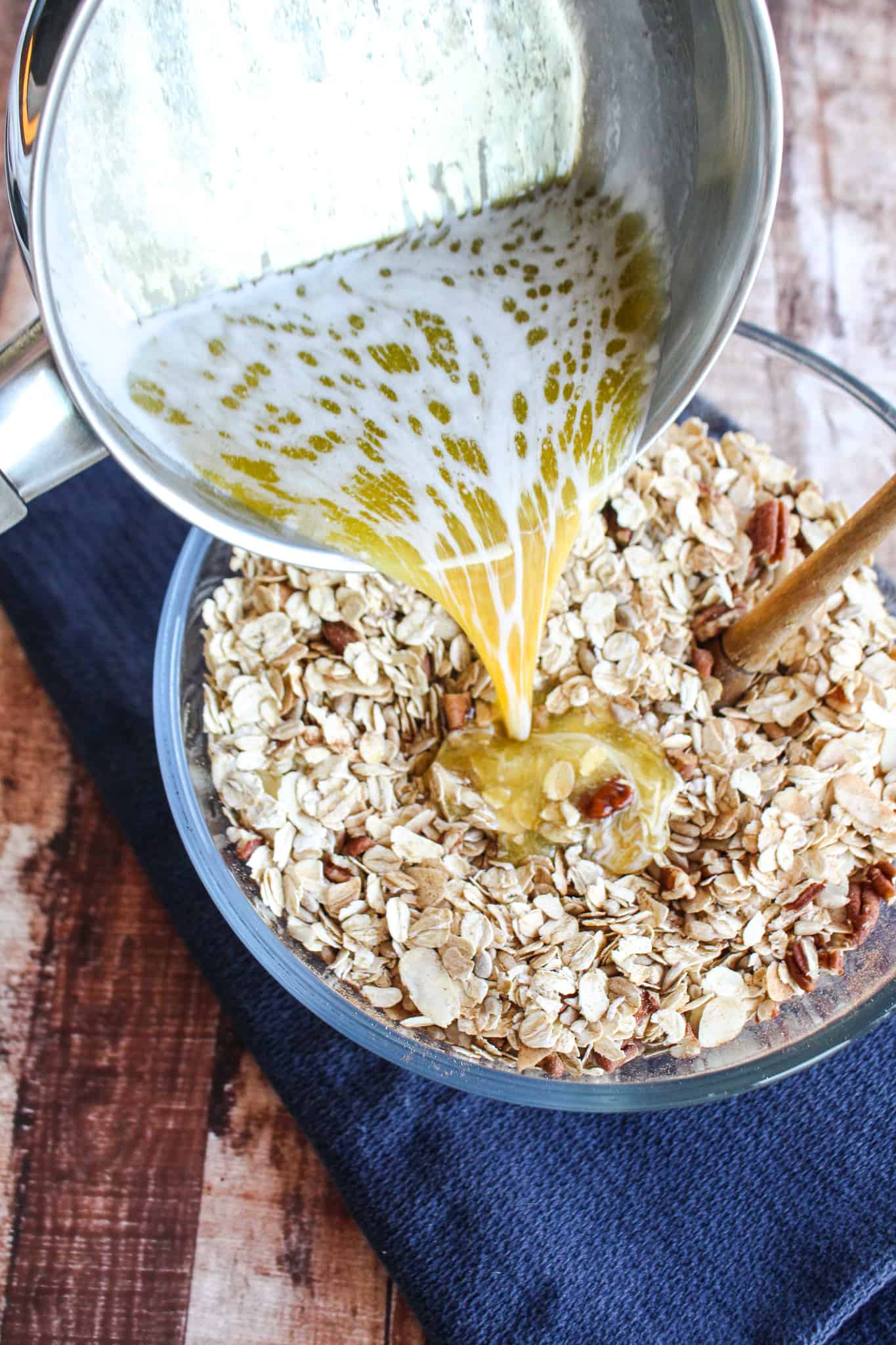 pouring melted butter into the oat and nut mixture