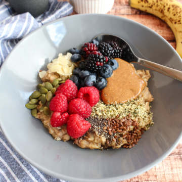 oatmeal with almond butter, fruits, seeds, and grains sprinkled on top