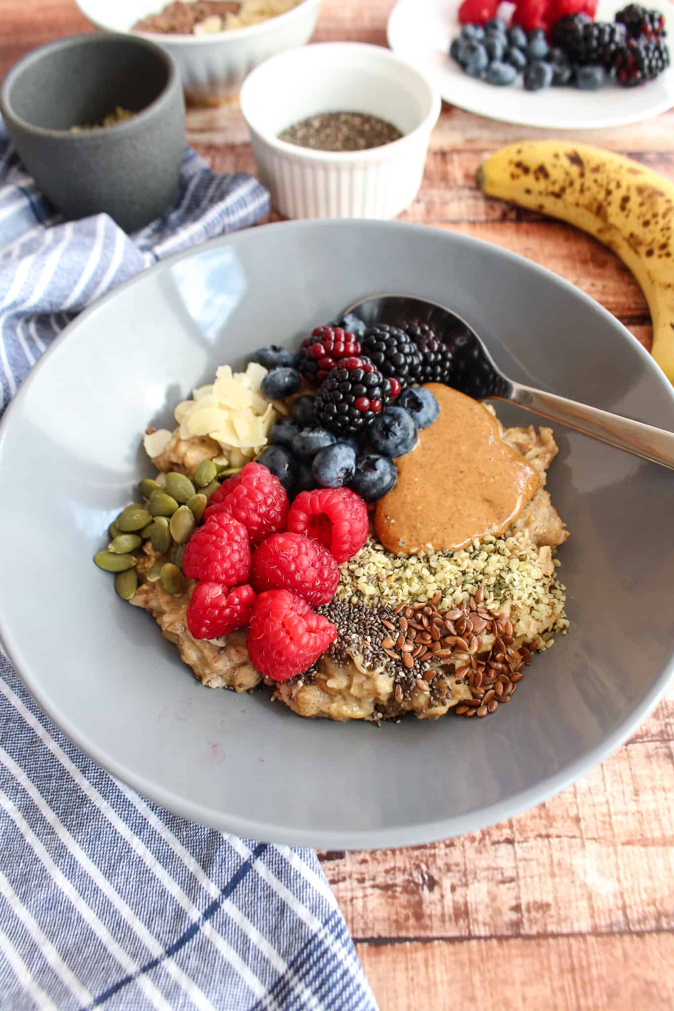 oatmeal with almond butter, fruits, seeds, and grains sprinkled on top