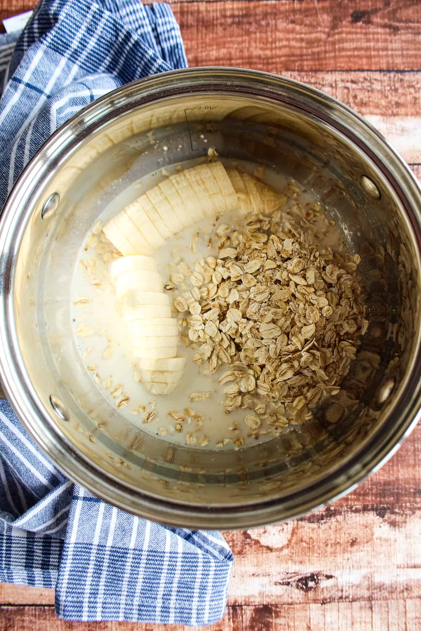 oats in a pot with water and a chopped banana