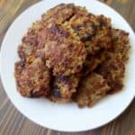 homemade maple sage breakfast sausage formed into patties on a white plate