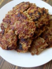 homemade maple sage breakfast sausage formed into patties on a white plate