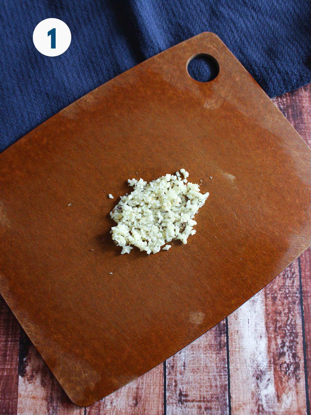 Garlic chopped on a cutting board.