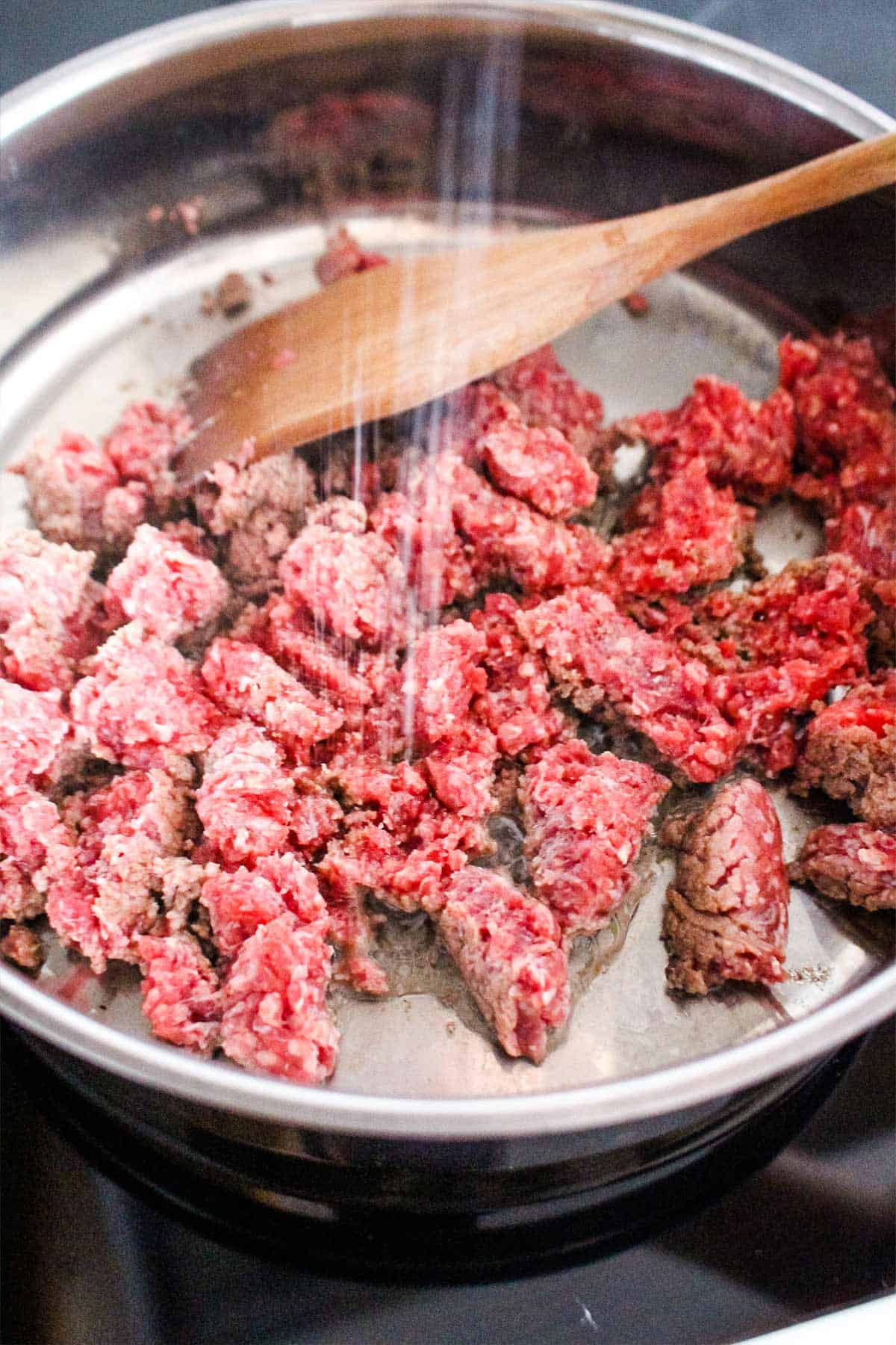 Ground beef cooking in a pan.