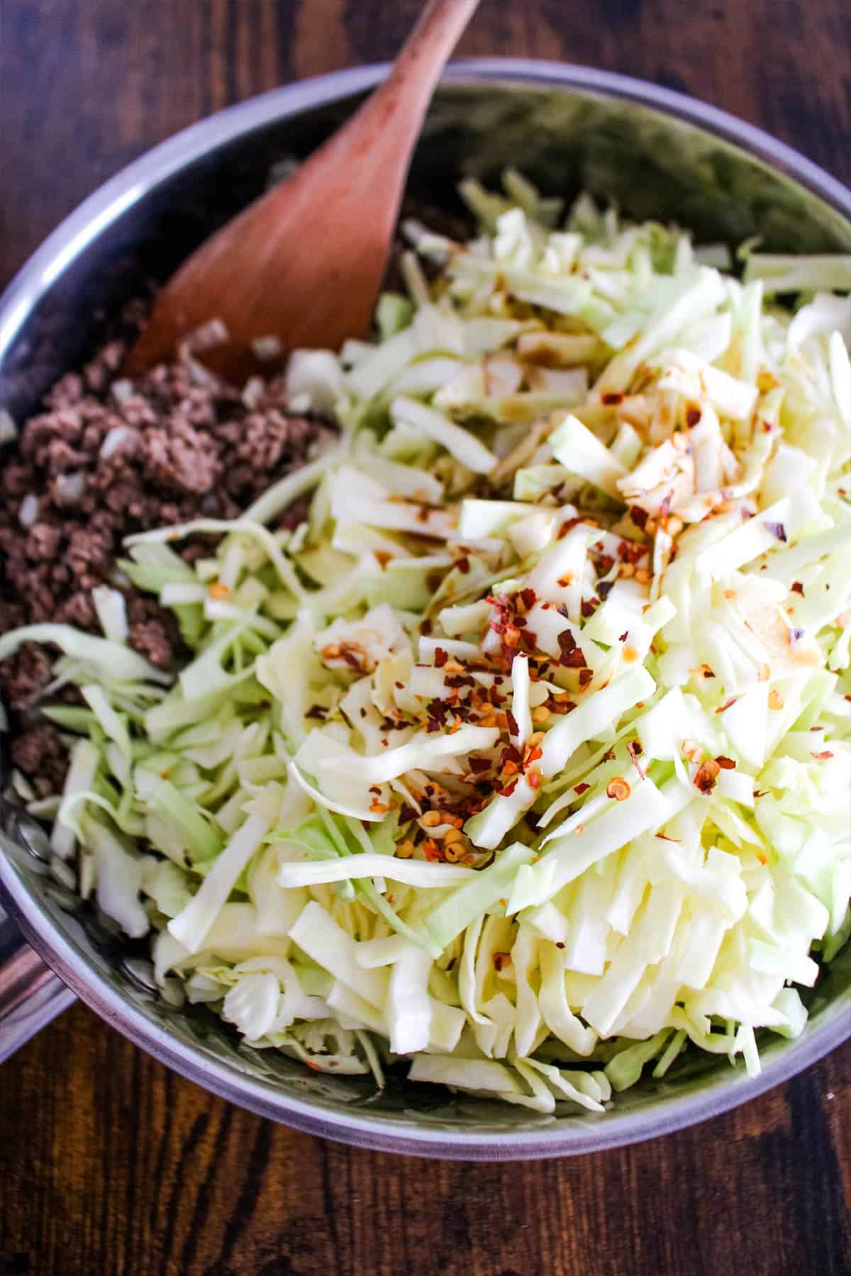 Seasonings and soy sauce added to the cabbage and ground beef.