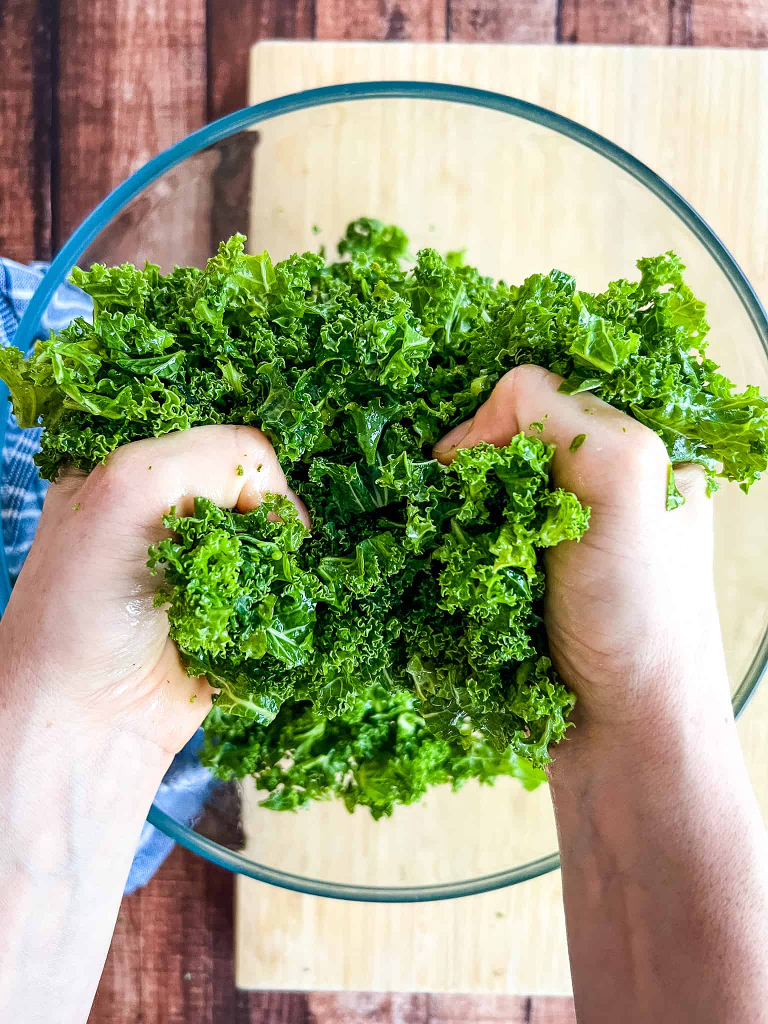 hands holding massaged kale