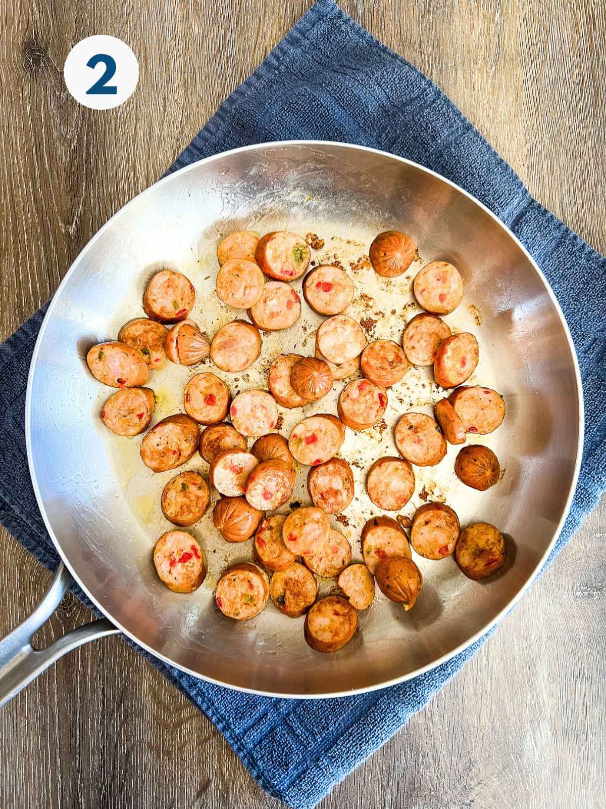 Sausage cooking in a skillet.