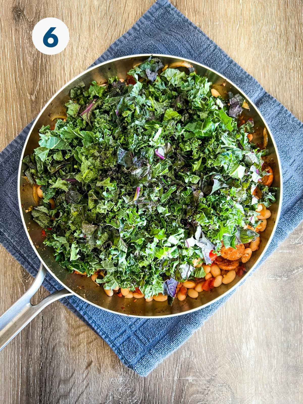 Kale is added on to the white bean and sausage skillet.