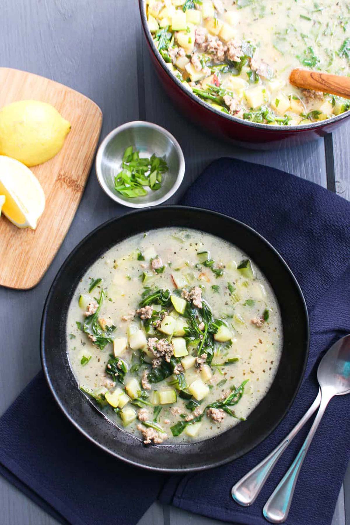 A bowl of ground pork soup with vegetables on the table.