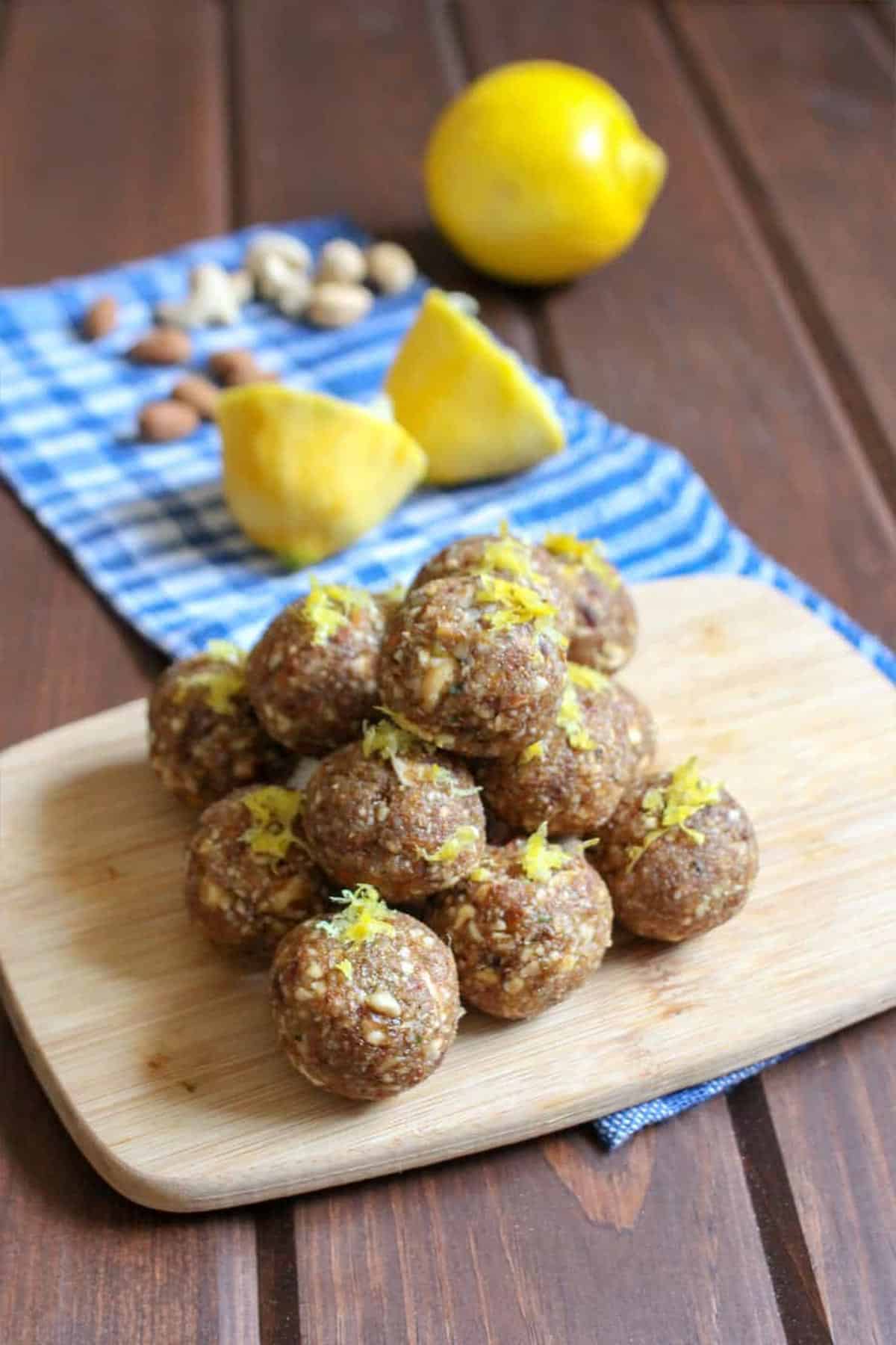 A stack of lemon date balls on the table.