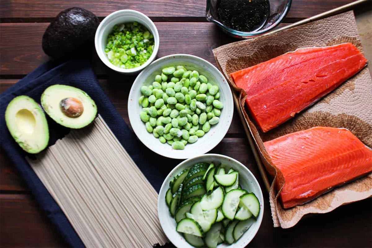 Ingredients on the table to make salmon soba noodles.