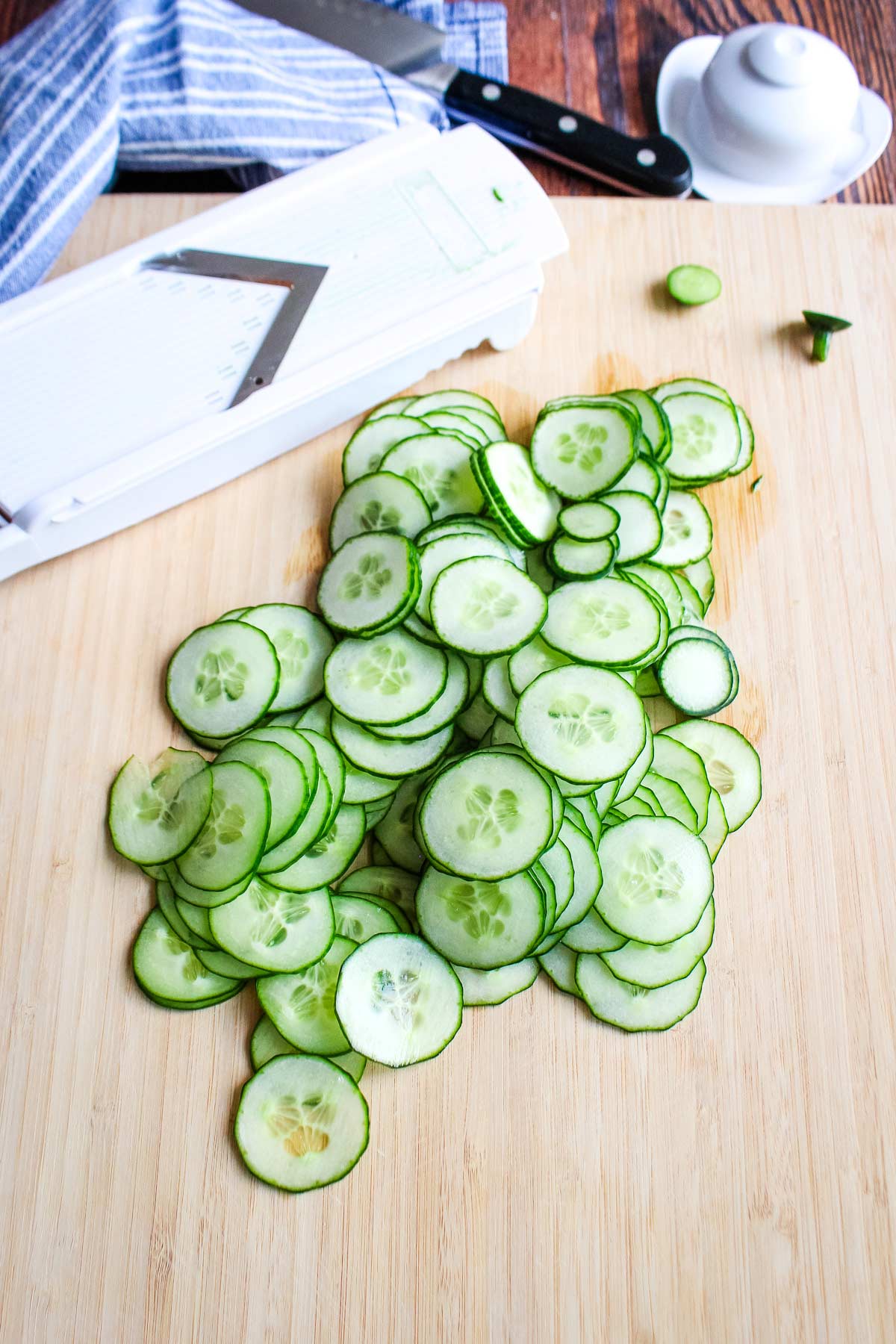 Sliced cucumbers on a cutting board.