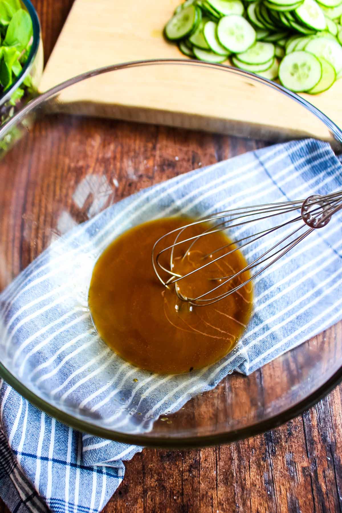 Ingredients to make the sesame dressing in a bowl with a whisk.