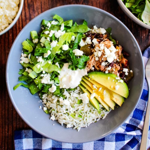 A slow cooker chicken burrito bowl on the table ready to eat!