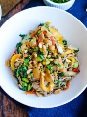 Soba noodles and veggies with a spicy peanut sauce in a bowl.