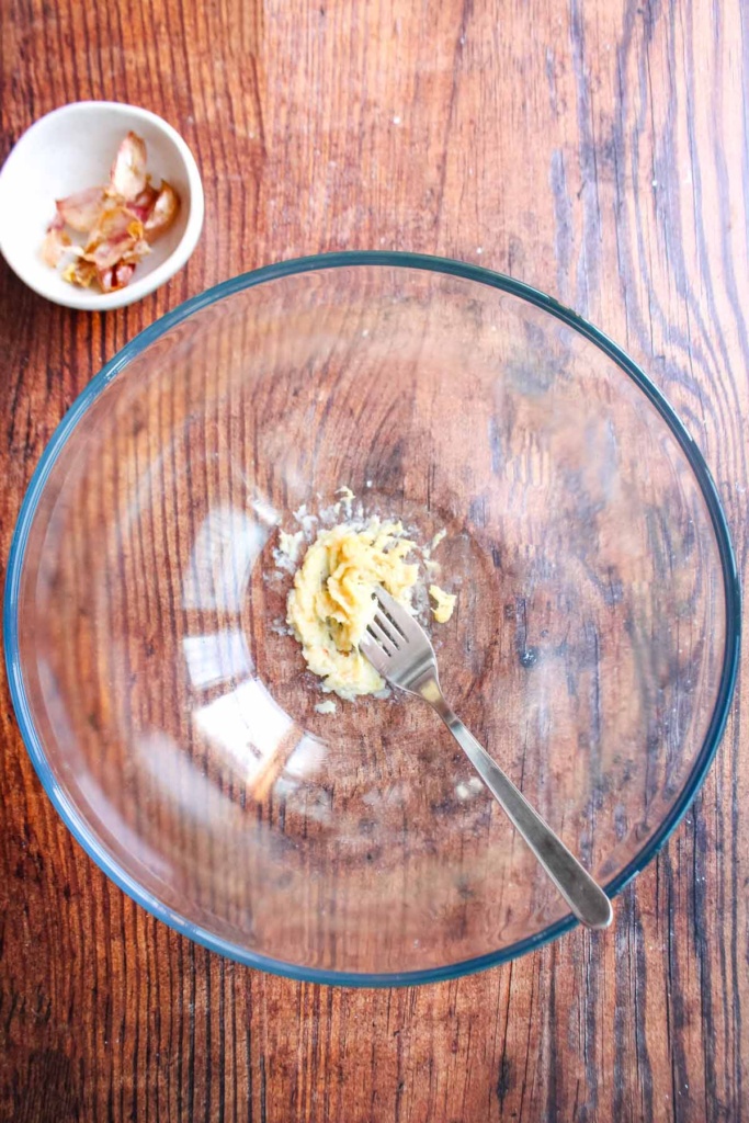 Garlic mashed in a bowl with a fork.