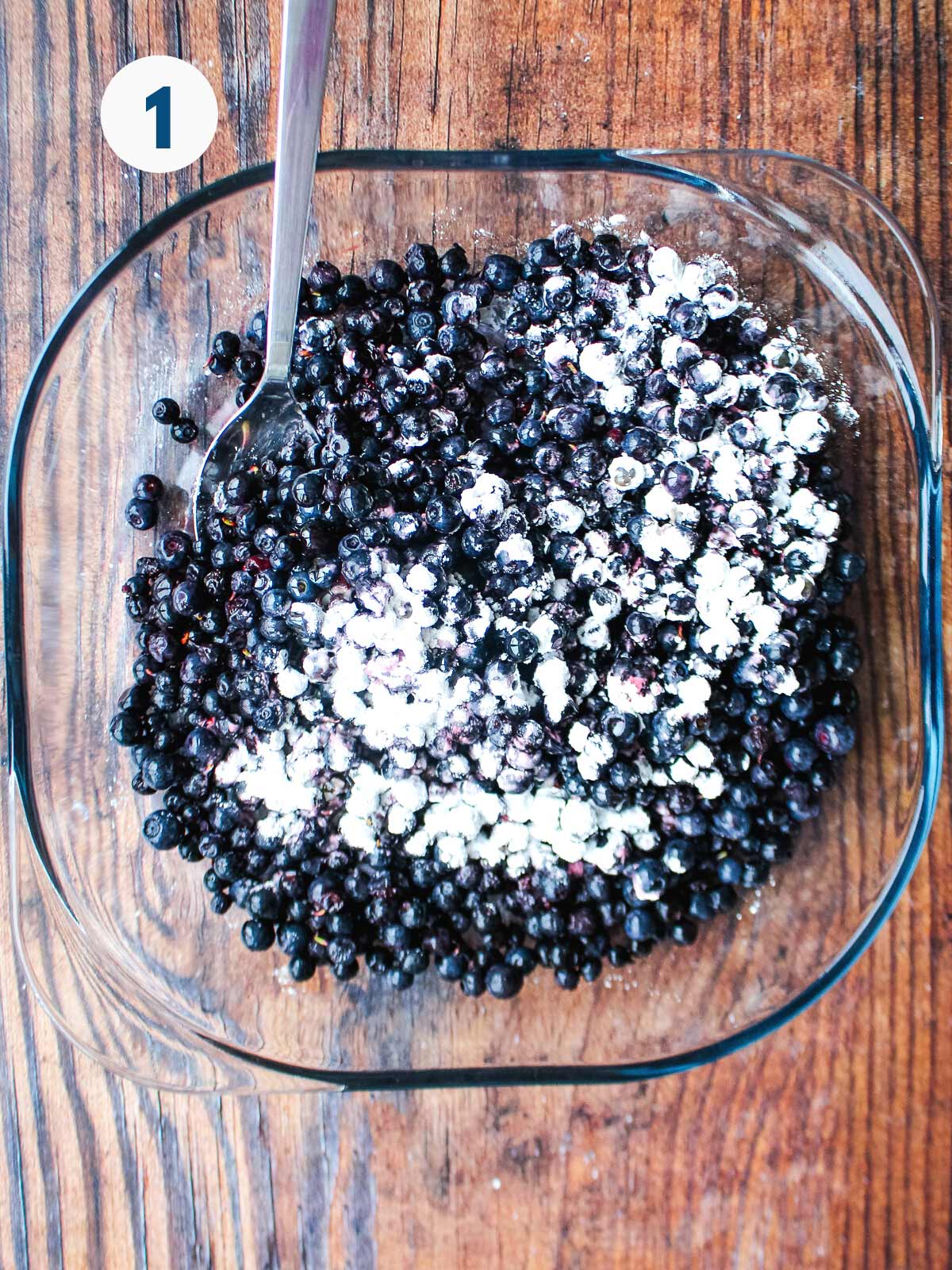 Blueberries and sugar in a bowl.