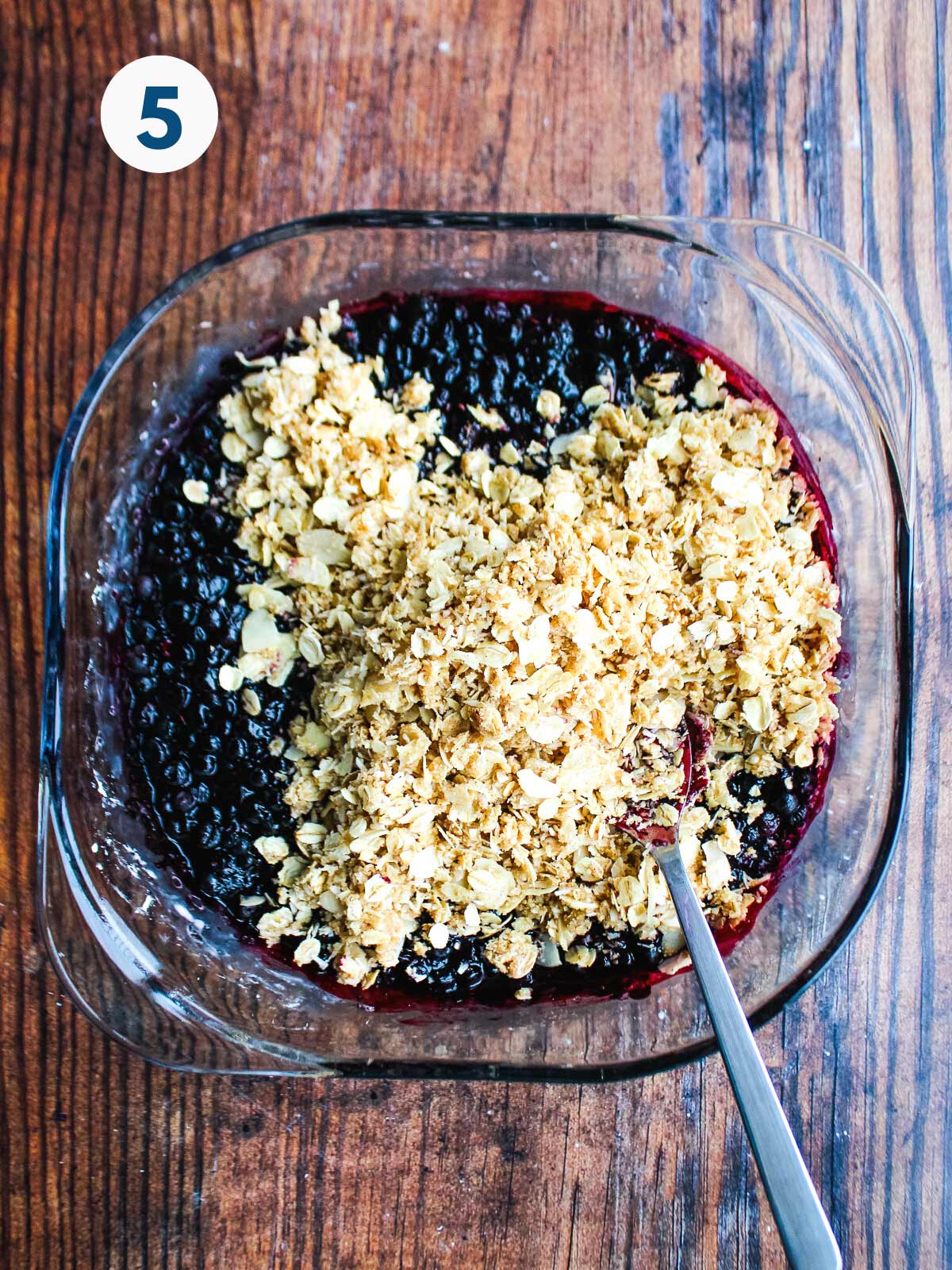 Oatmeal topping added to the top of the blueberries.