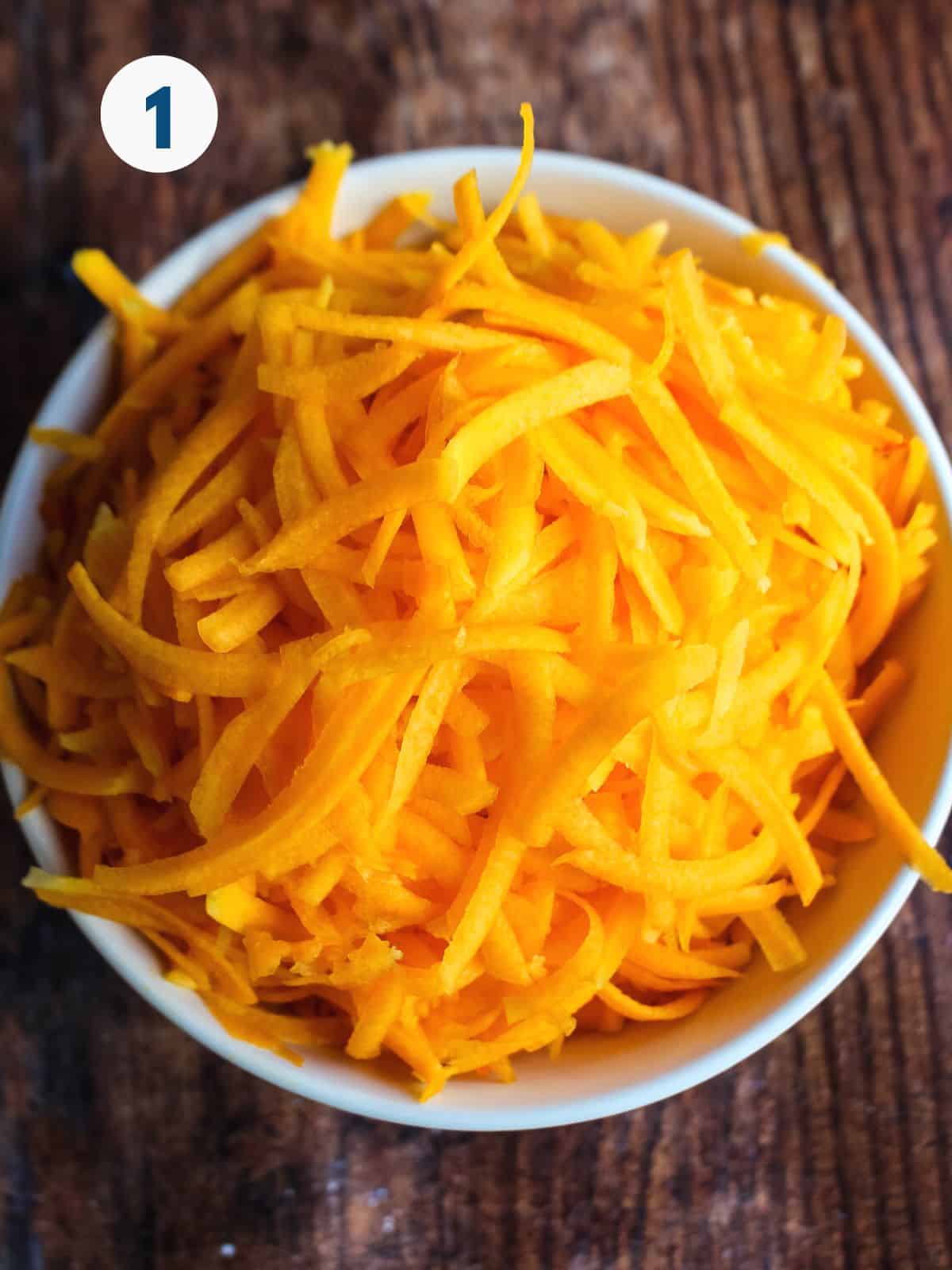 Grated butternut squash in a bowl.