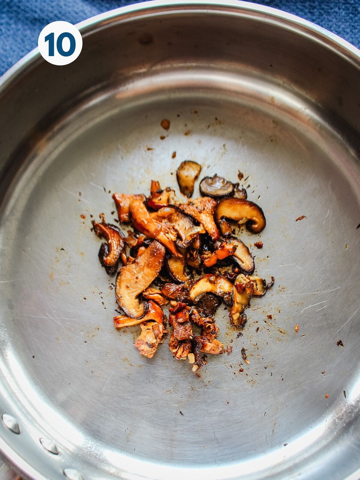 Mushrooms for topping browning in a skillet.