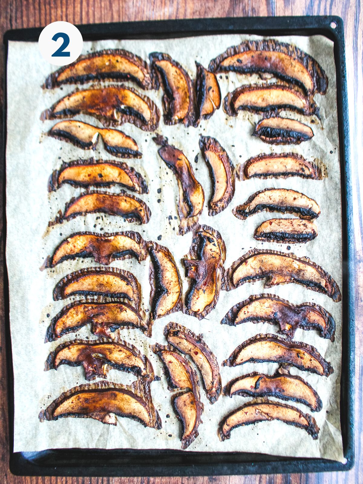 Sliced portobello mushrooms cooked on a baking tray.