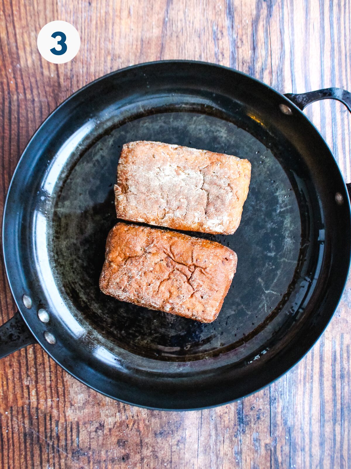 Toasting the bread in a skillet.