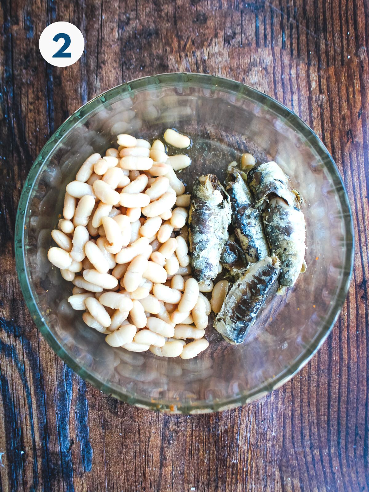 Sardines and cannellini beans in a bowl.