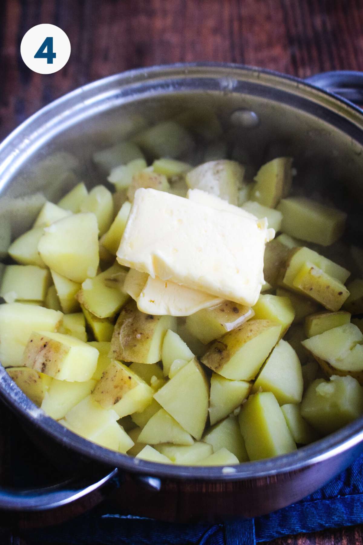 Adding butter to the mashed potatoes.