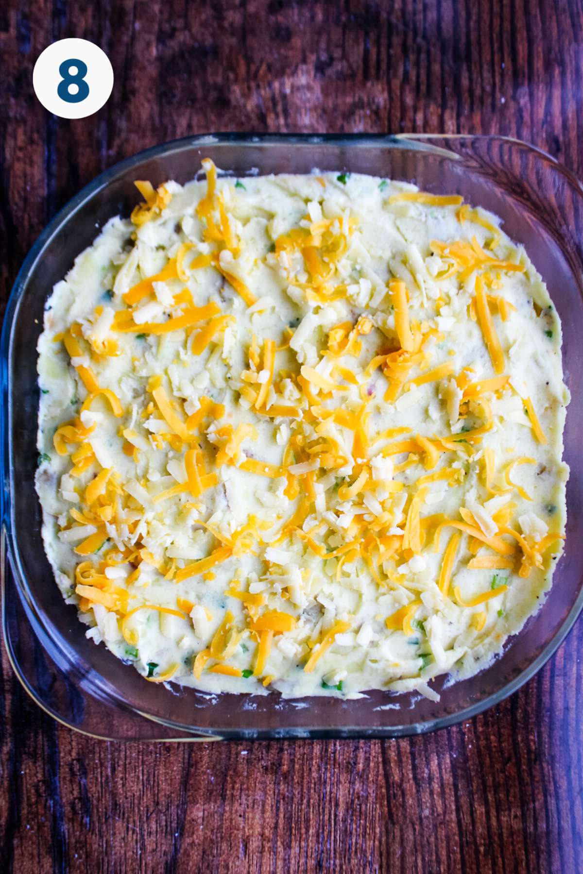 Cheese sprinkled over the top of the mashed potato casserole.