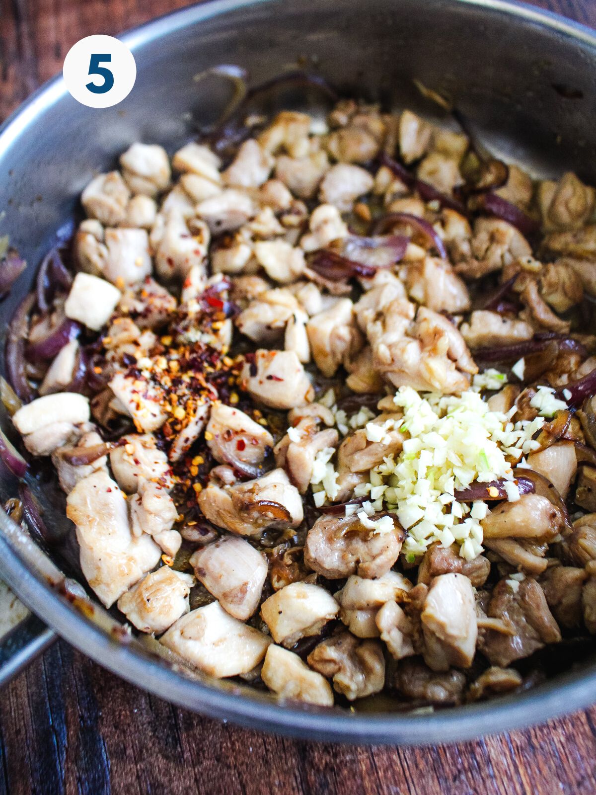 Ground chicken cooking in a skillet.