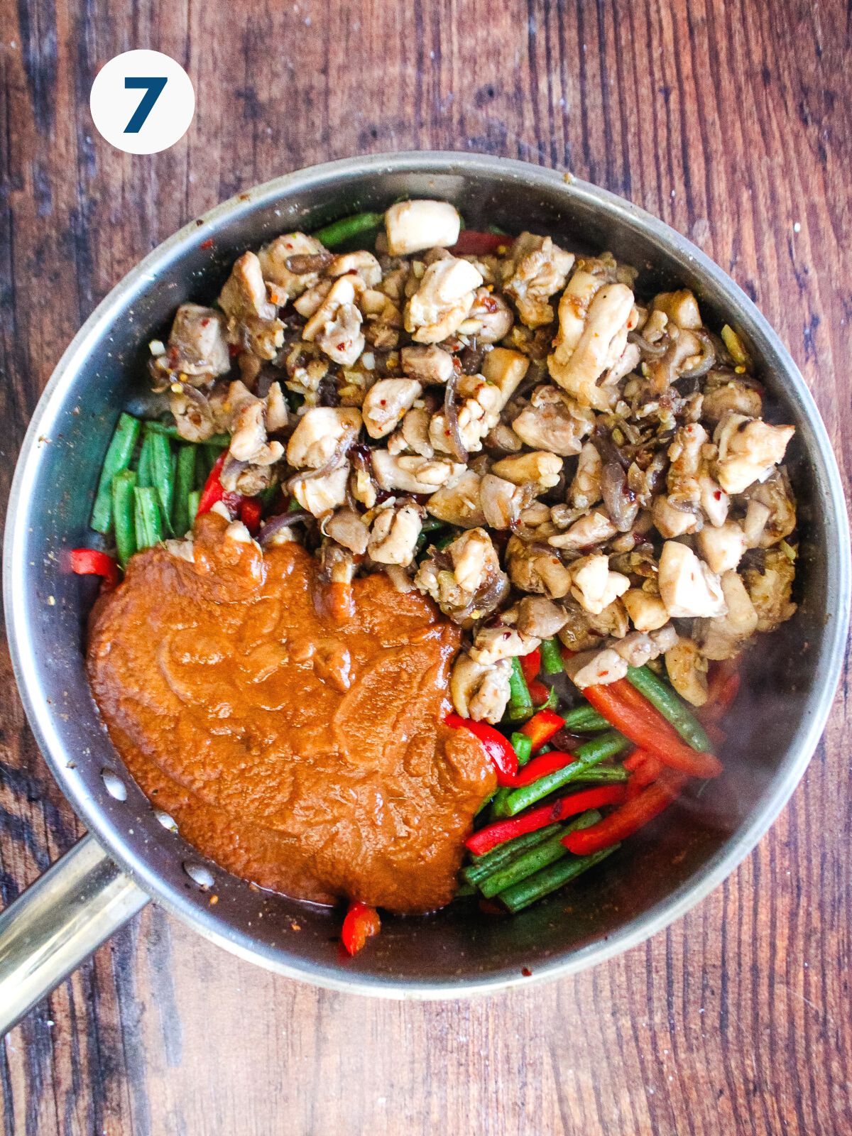 Vegetables and sauce added to the pan with the cooked meat.