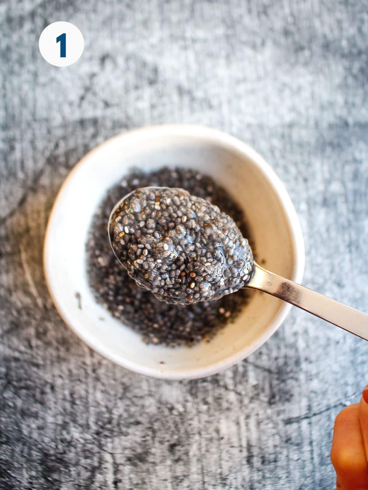 Mixing chia seeds with water in a small bowl.