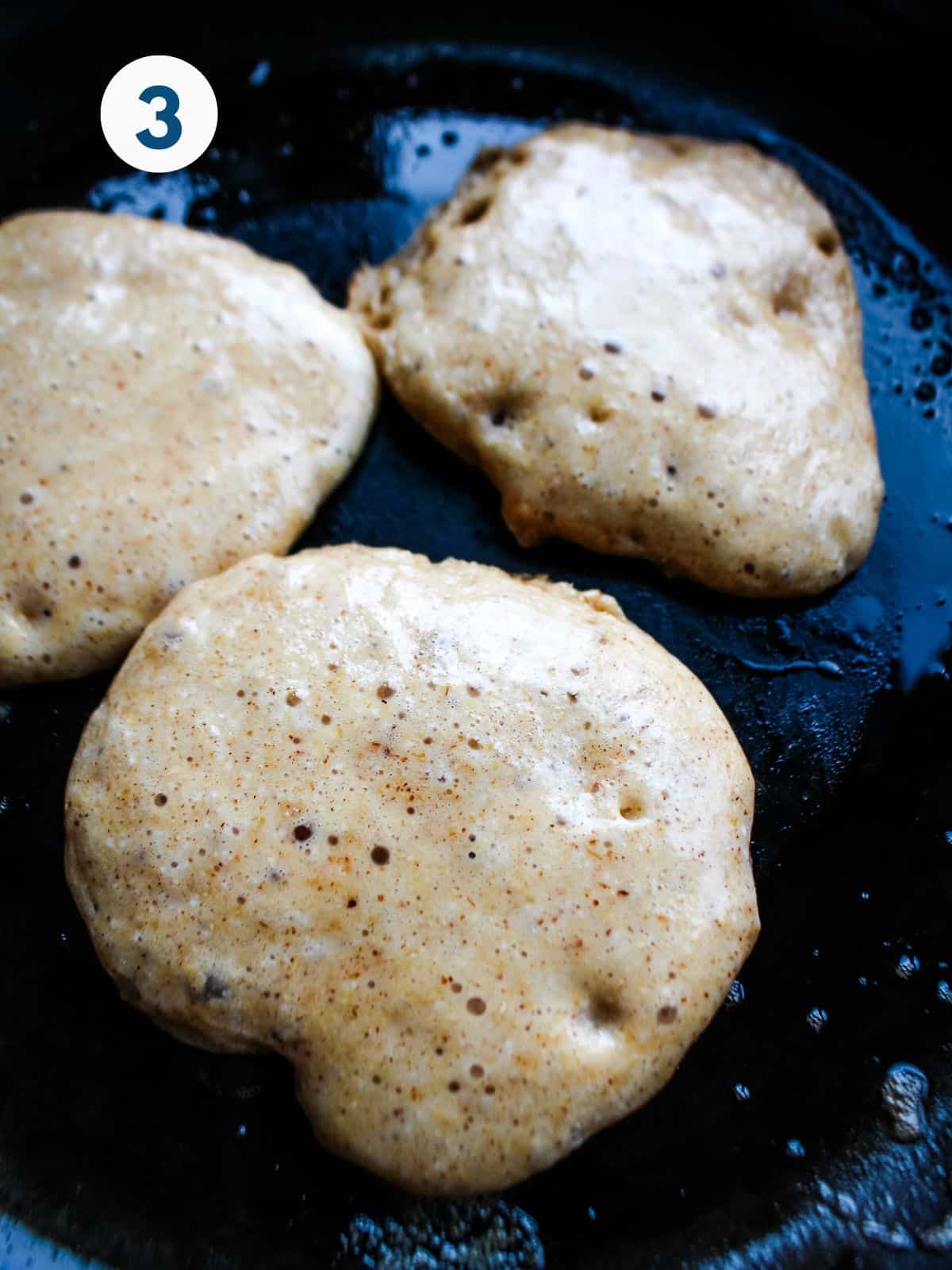 Pancake batter poured into a skillet to cook.