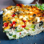 A slice of healthy turkey frittata on a blue plate.