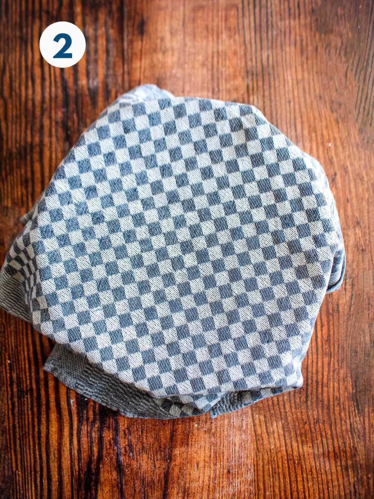 Bowl of buckwheat groats covered with a towel.