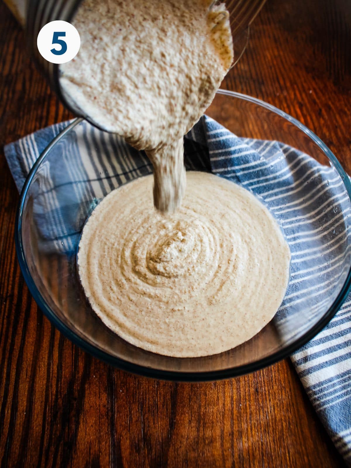 Pouring the buckwheat bread batter into a bowl.