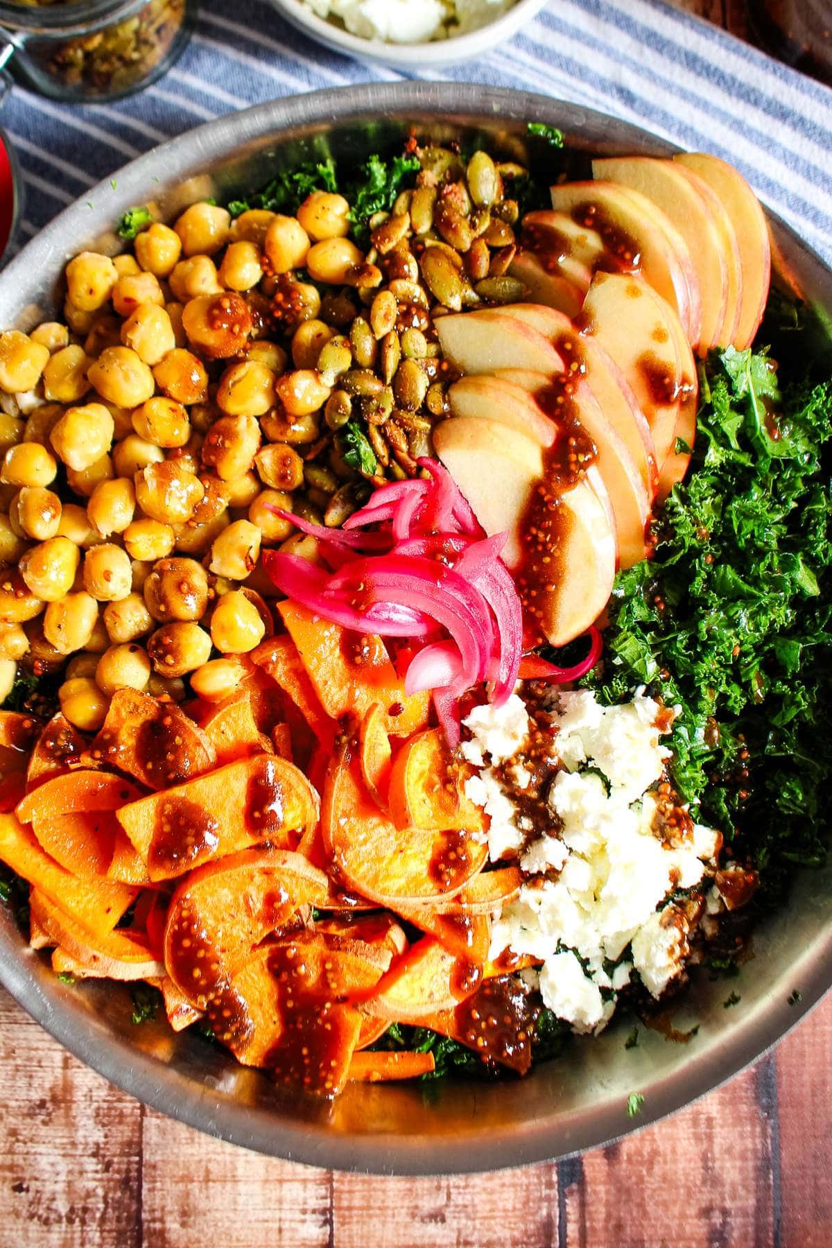 A salad with mustard balsamic dressing drizzled on top.