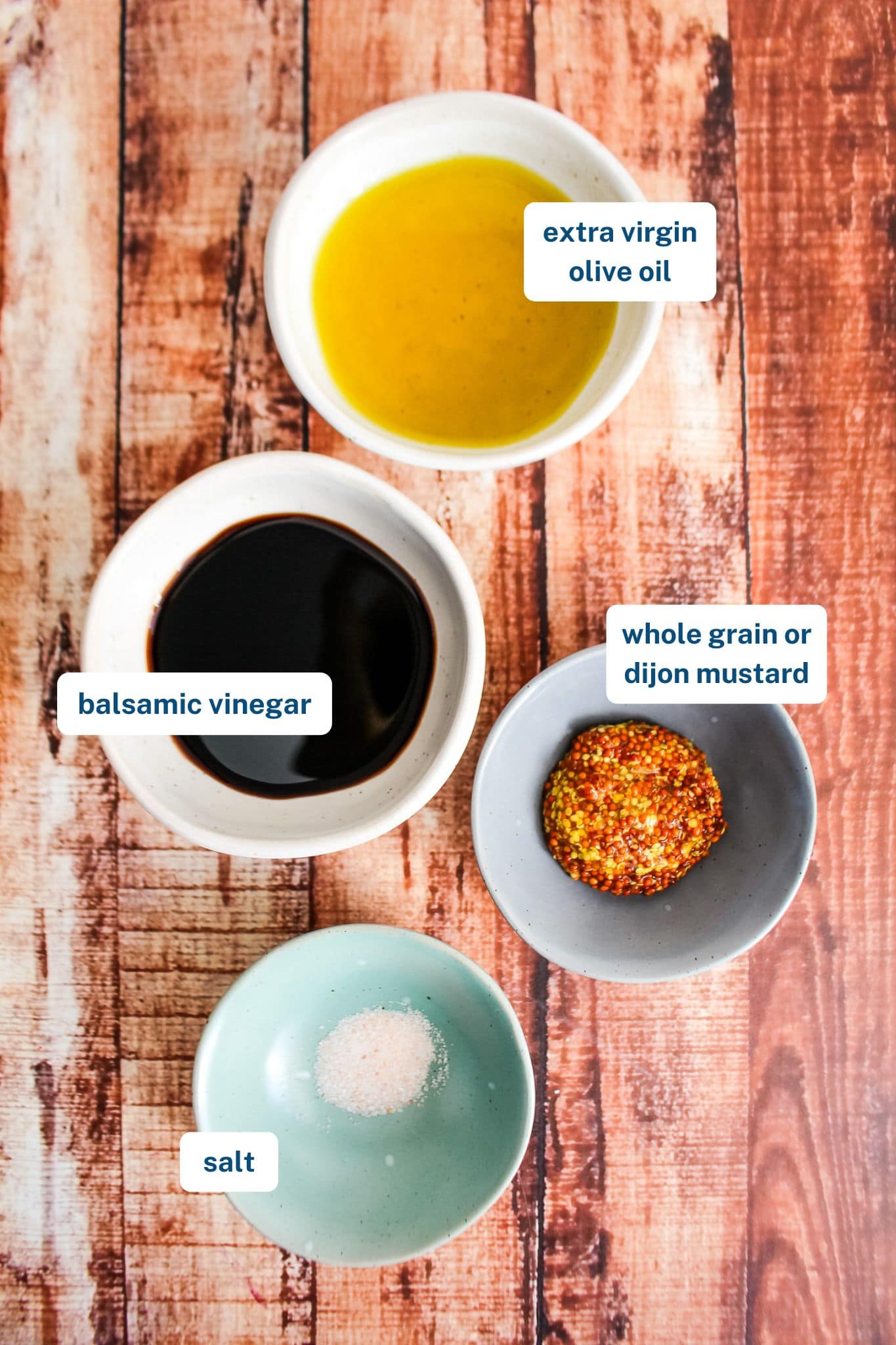 Ingredients to make mustard balsamic vinaigrette on the table.