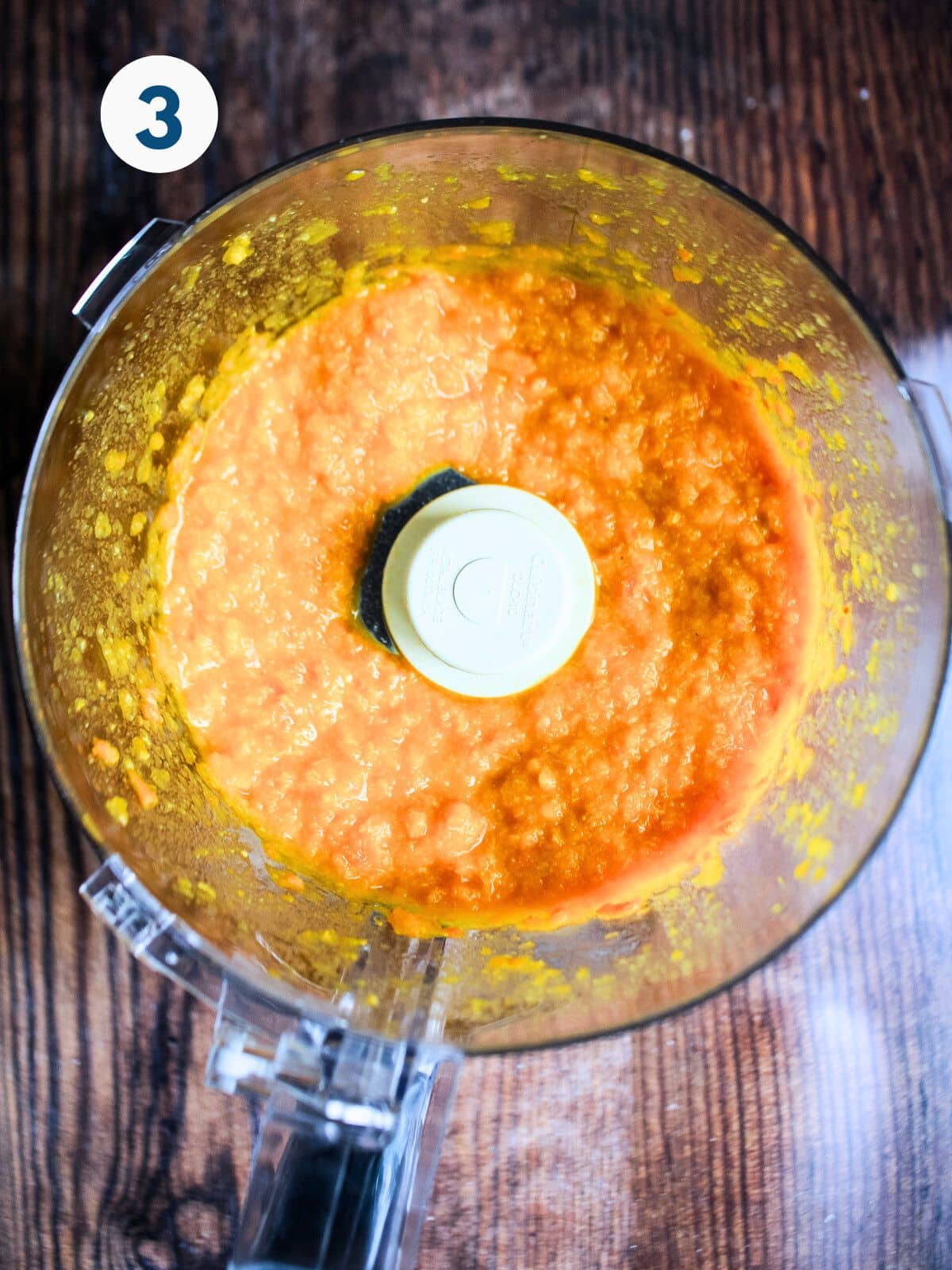 Clementines pureed in a food processor bowl.