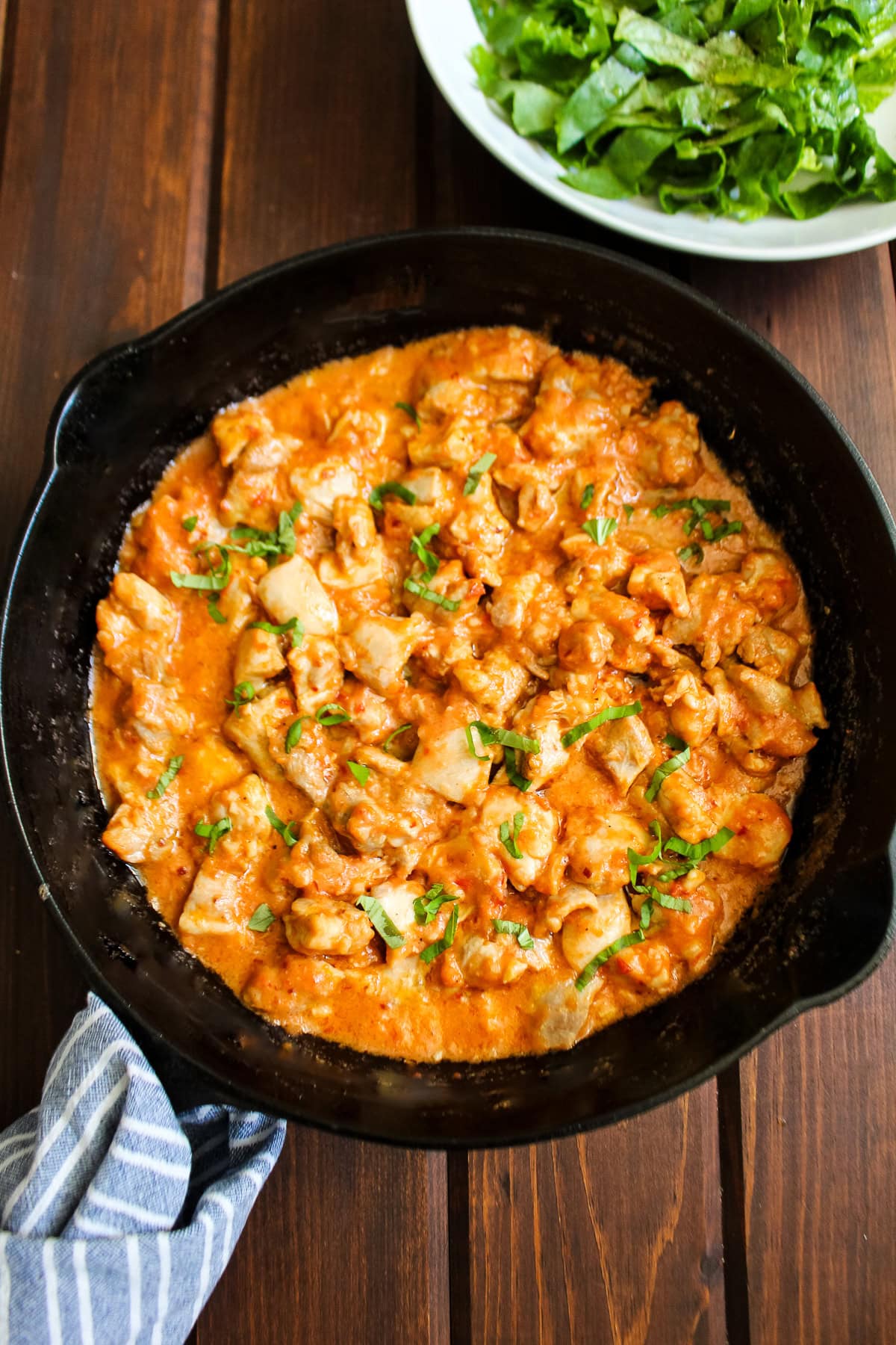 Cottage cheese sauce chicken in a cast iron skillet.