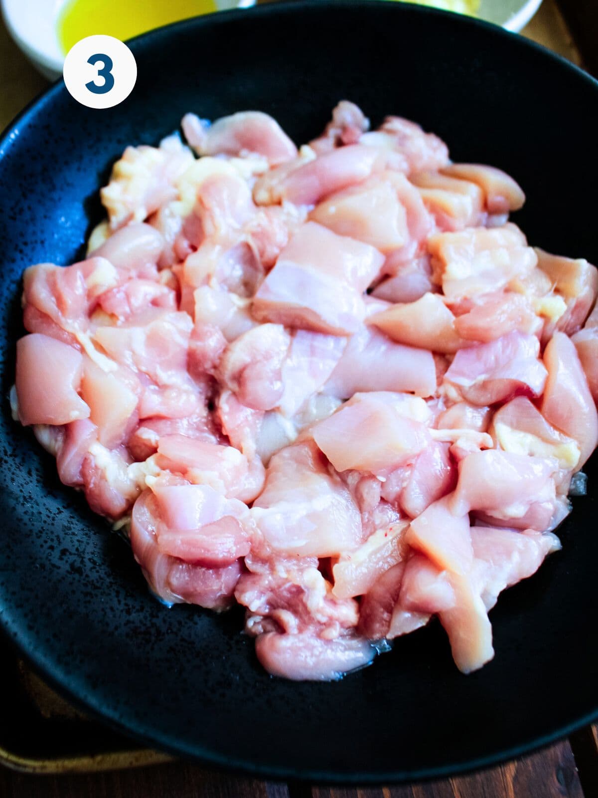 Chicken cooking in a skillet.